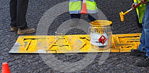 Road workers paint lane markings for taxis with yellow Marcas Viales color in Portugal photo