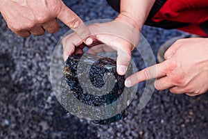 Road workers take a cube of asphalt
