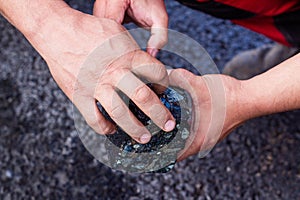 Road workers take a cube of asphalt