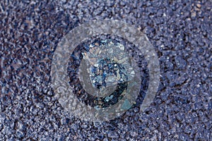 Road workers take a cube of asphalt