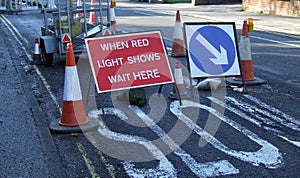 Road works with when red light shows wait here sig