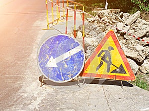 Road works sign closeup. Road sign repair work. Roadwork warning signs on the side of the road on a sunny day