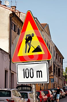 Road works sign for construction works in city street. Road under construction traffic sign. Traffic, warning sign road repairing.