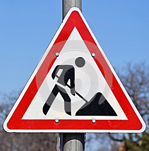 Road works sign at the road crossing