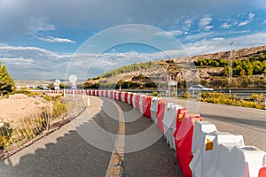 Road works sign on the road. Repair work of road signs and a bypass arrow