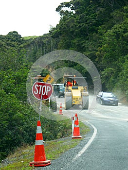 Road works: stop sign, machinery and cars