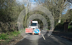 Road works with traffic light control on a country lane in Kent, England, United Kingdom