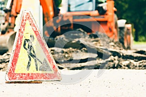 Road works warning sign with damaged surface,  symbol