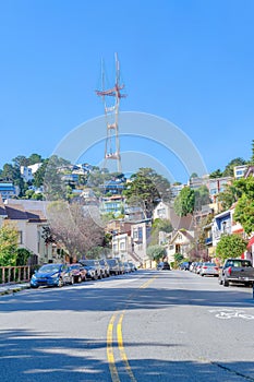 Road with yellow lines and roadside parking near the Sutro Tower in San Francisco, CA