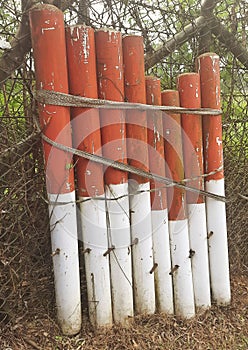 roadblocks leaning against the fence