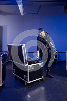 Roadie picking some cables out of a flightcase