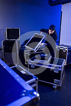 Roadie unpacking a dj mixing table