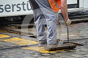 Roadman repairs streetcar rails