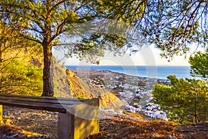 Roadside bench at Mesa Vouno mountain above Kamari village Santorini Greece