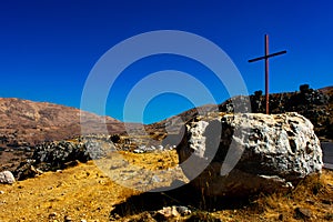 Roadside cross in a mountain area photo