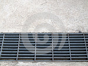 roadside manhole drain sewer closed with gray cover steel gratings