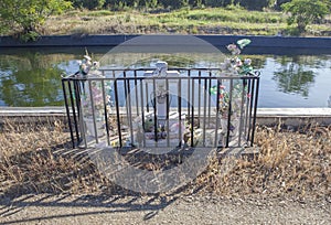 Roadside memorial to crash victim beside irrigation canal