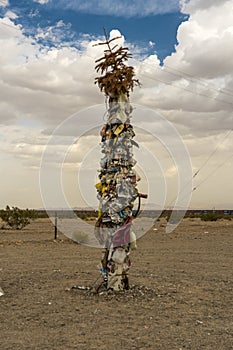 Roadside pole with things stuck to it, along Old Route 66 San Bernadino County, California along Interstate 40