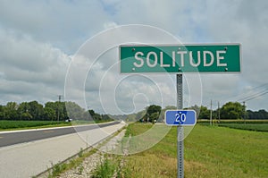 Roadside road sign for the small town of SOLITUDE