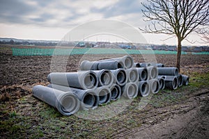 On the roadside there are concrete pipes that are to be laid