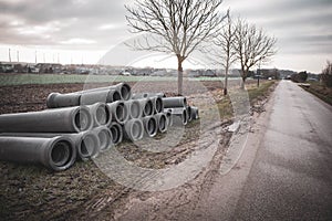 On the roadside there are concrete pipes that are to be laid