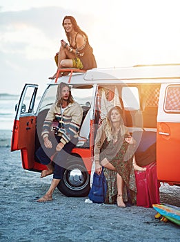 Roadtrips are about the stops along the way. a group of young friends stopping at the beach during a roadtrip.