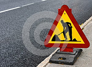 Roadwork sign at the side of a road photo