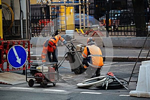Roadworkers on repair of road surface