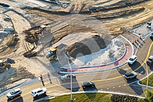 Roadworks construction site at roundabout intersection on American highway. Development of city circular transportation