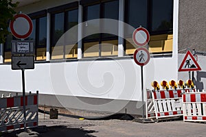 Roadworks, no entry signs for vehicles, pedestrians and an extra sign for bikers to step down