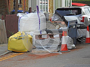 roadworks repair construction building site skip refuse site concrete bags sacks works