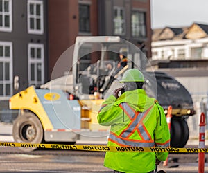 Roadworks signal with worker standing. Traffic control manager watching order on the urban road