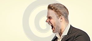 Roar of anger. Businessman scream in anger. Angry manager. Man face portrait, banner with copy space. Business man in