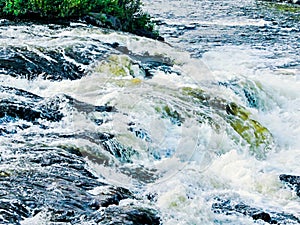 Roaring water cascade on a river bend