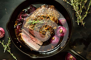 Roast beef with caramelized in wine red onions in cast iron skillet. Traditional American cuisine dish specialty for family dinner