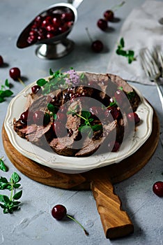 Roast beef with cherry sauce.style rustic