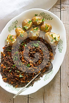 Roast beef ground with vegetables and baked potato