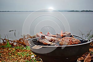 Roast beef on a hot stove in the morning with heavy fog, River