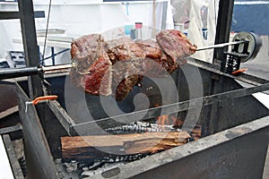 Roast beef on outdoor rotisserie photo
