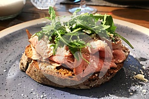 Roast beef sandwich on a plate in a restaurant. Served table