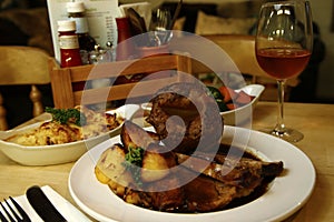 Roast beef served with cauliflower cheese, a dish of mixed fresh vegetables & gravy