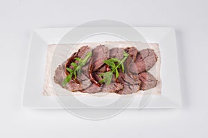 Roast beef with tuna sauce and herbs on white background