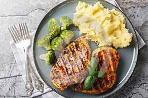 Roast breast grilled chicken with broccoli and mashed potatoes closeup on the plate. Horizontal top view