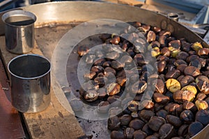 Roast chestnuts cooked over the gril at market