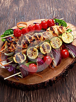 Roast Chicken filet kebab with cherry grilled on BBQ. tomatoes, zucchini and red onions on bamboo sticks