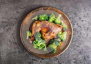 Roast chicken Leg. Chicken roasted leg with broccoli on concrete