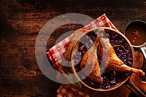 Roast Chicken leg on red cabbage in a pan