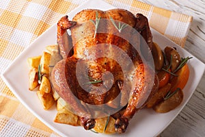 roast chicken with oranges, potatoes and apples close-up. horizontal