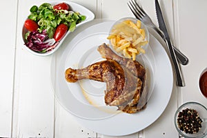 Roast chicken thighs and fries, and salad of lettuce and tomato