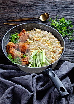 Roast chicken thighs with pasta in a skillet